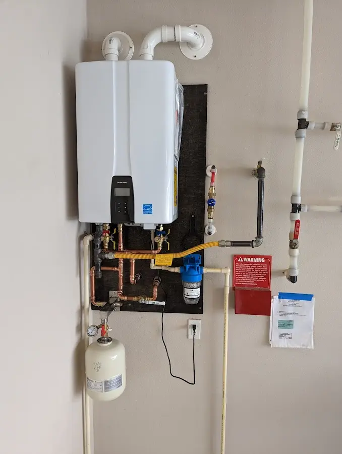 Professional plumber installing copper piping in a Roseland home